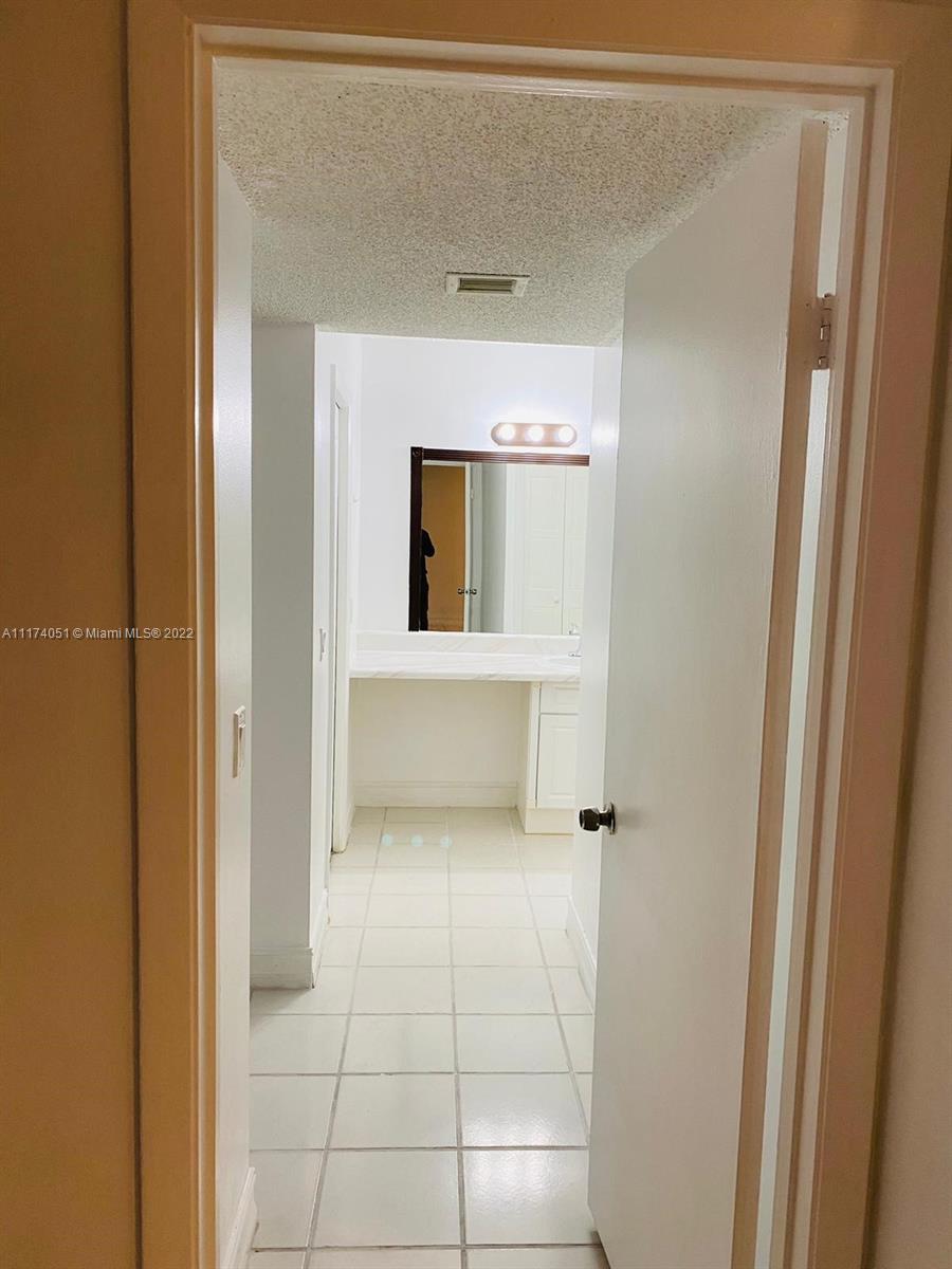 380 Racquet Club Road, Unit 103 Weston, FL 33326 - Photo 10 of 25 a bathroom with a sink and a mirror