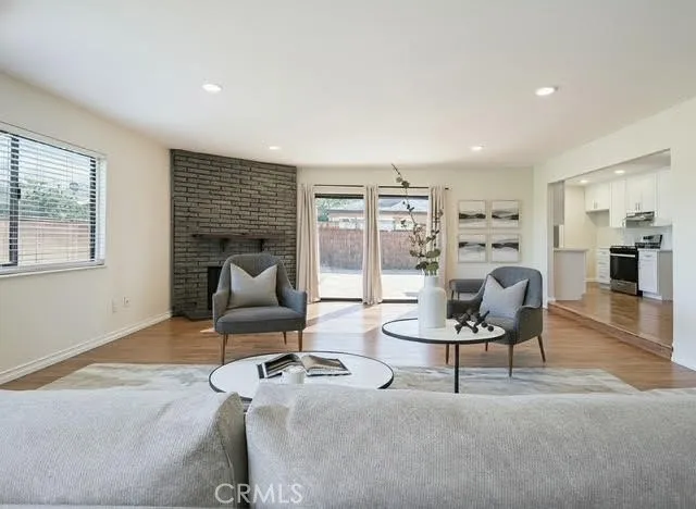 a living room with furniture and a floor to ceiling window