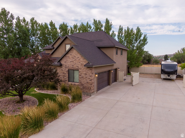 3565 West 1350th Street North Vernal, UT 84078 - Photo 4 of 54 Stucco and brick exterior with a dark shingle roof