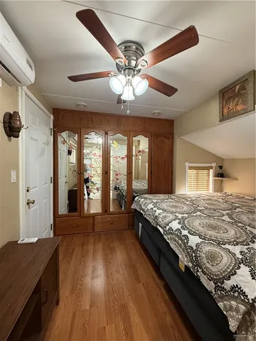 a spacious bedroom with a bed and a chandelier