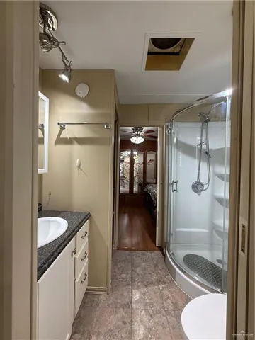 a bathroom with a toilet and a shower