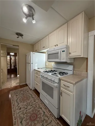 a kitchen with cabinets appliances and a counter top space