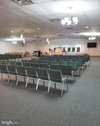 a view of a dining room with furniture and a chandelier