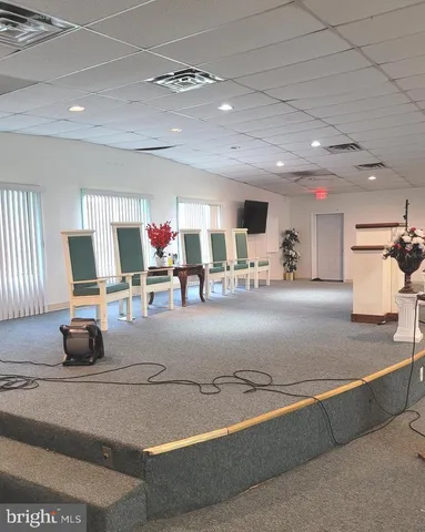 a living room with lots of furniture and gym equipment