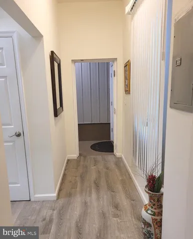 a view of a closet with wooden floor