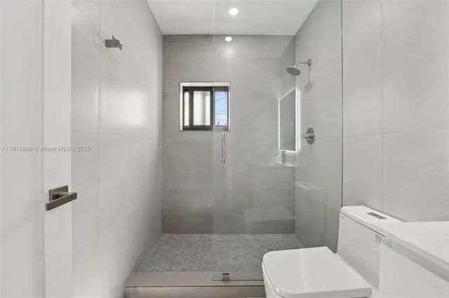 a bathroom with a toilet and shower