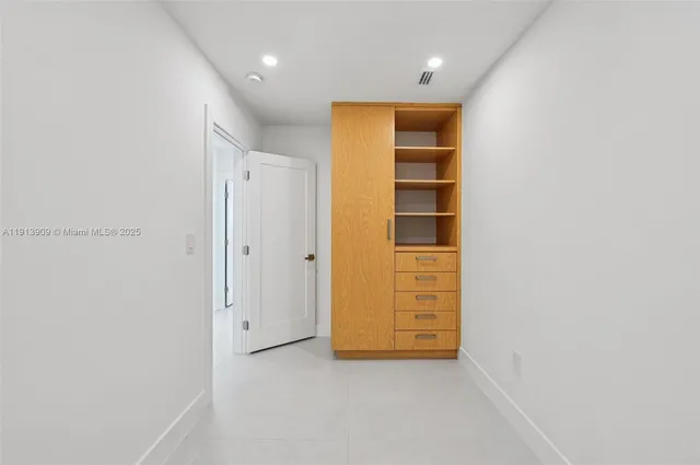 an empty room with closet area
