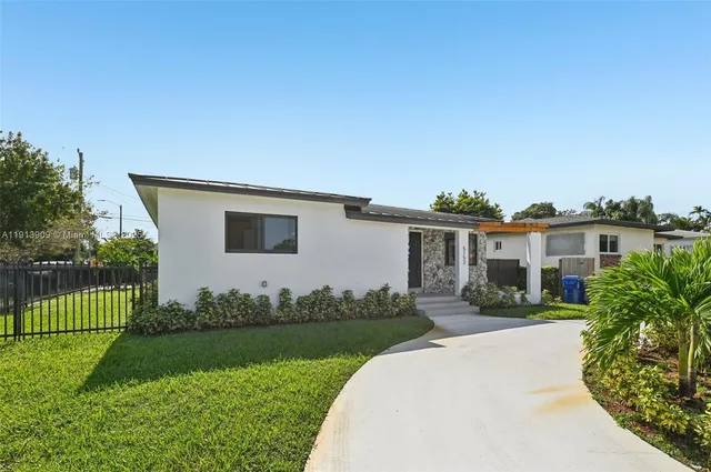 a front view of a house with a garden