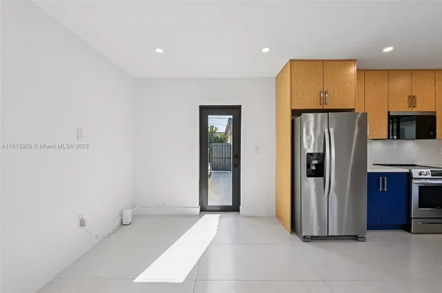 a kitchen with stainless steel appliances a refrigerator and a stove
