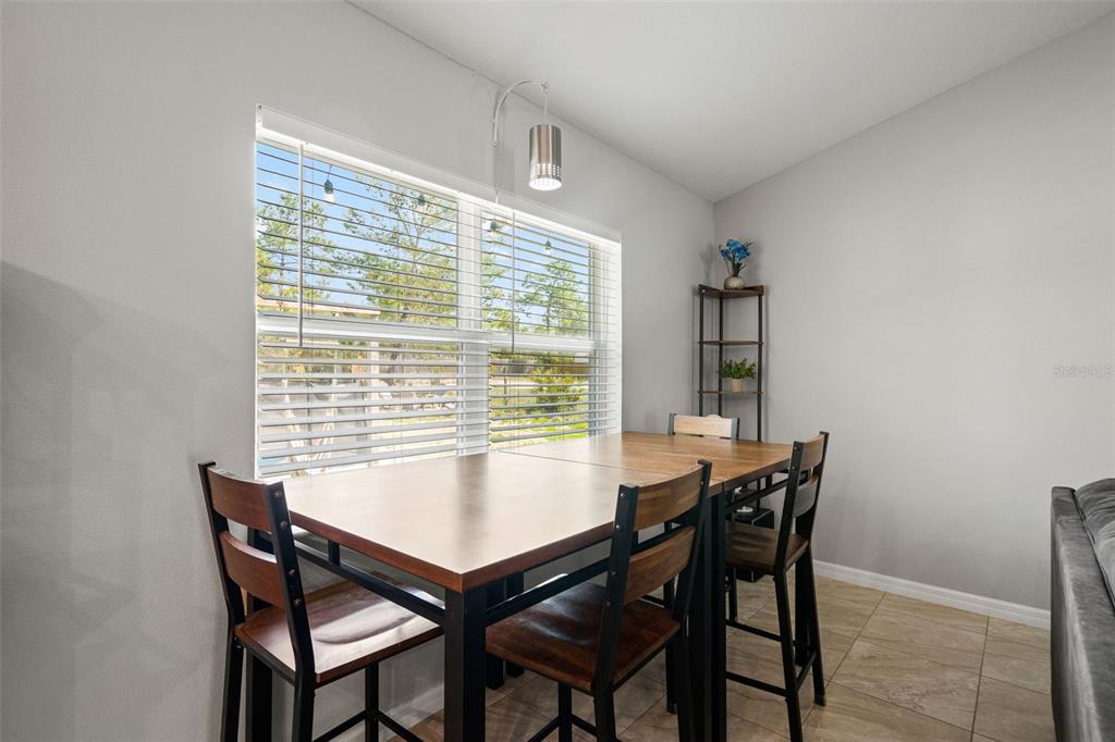 12015 Phoenix Avenue Weeki Wachee, FL 34614 - Photo 13 of 39 a view of a dining room with furniture and window