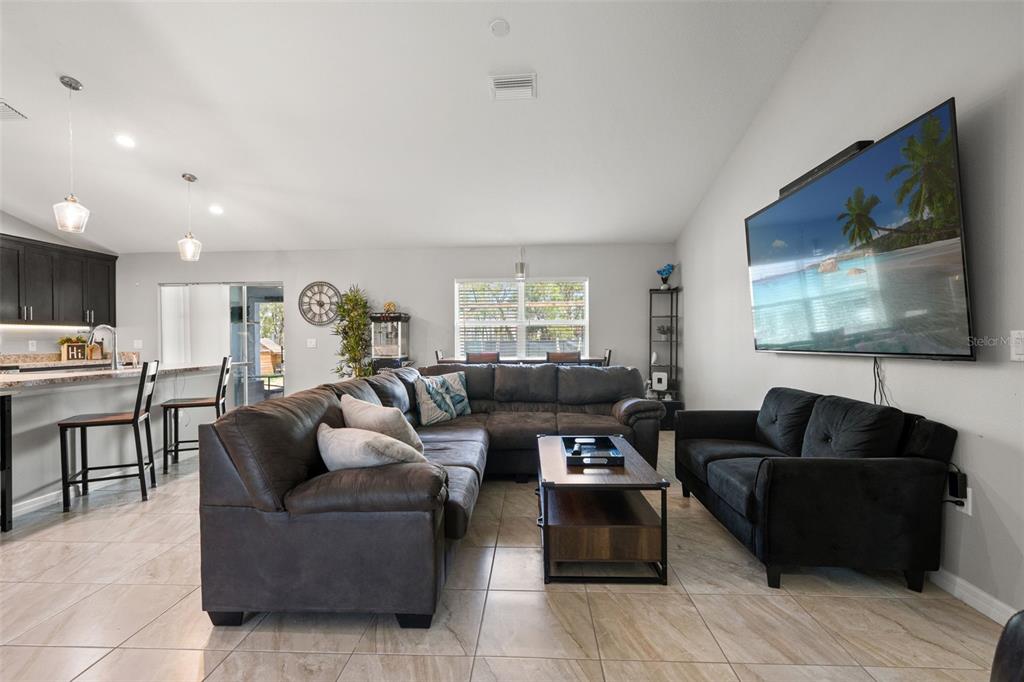 12015 Phoenix Avenue Weeki Wachee, FL 34614 - Photo 15 of 39 a living room with furniture and a flat screen tv