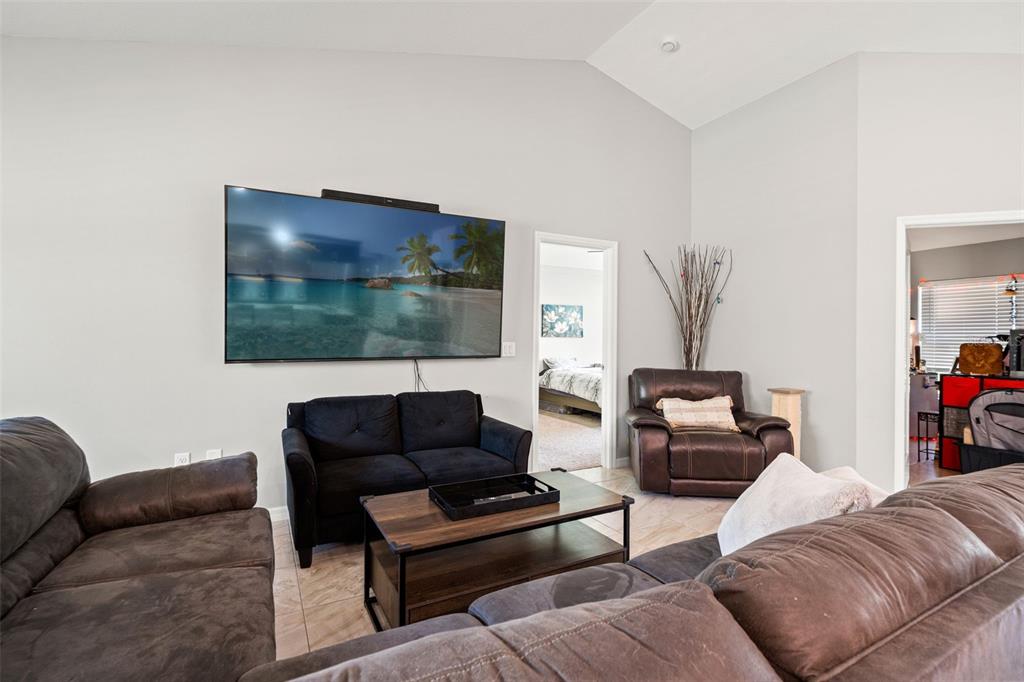 12015 Phoenix Avenue Weeki Wachee, FL 34614 - Photo 16 of 39 a living room with furniture and a flat screen tv