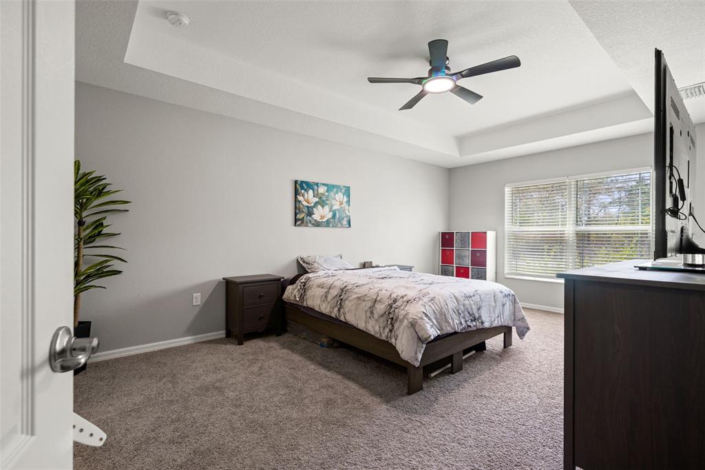 12015 Phoenix Avenue Weeki Wachee, FL 34614 - Photo 17 of 39 a spacious bedroom with a bed and a window