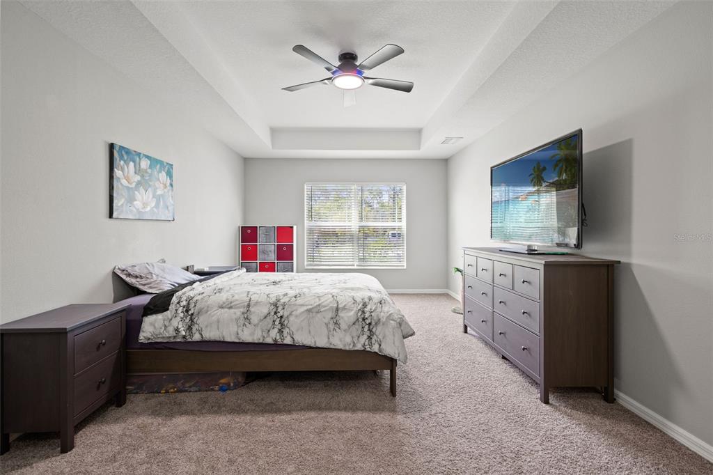 12015 Phoenix Avenue Weeki Wachee, FL 34614 - Photo 18 of 39 a bedroom with a bed and a flat screen tv