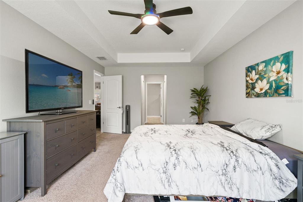 12015 Phoenix Avenue Weeki Wachee, FL 34614 - Photo 19 of 39 a bedroom with a bed and a flat screen tv