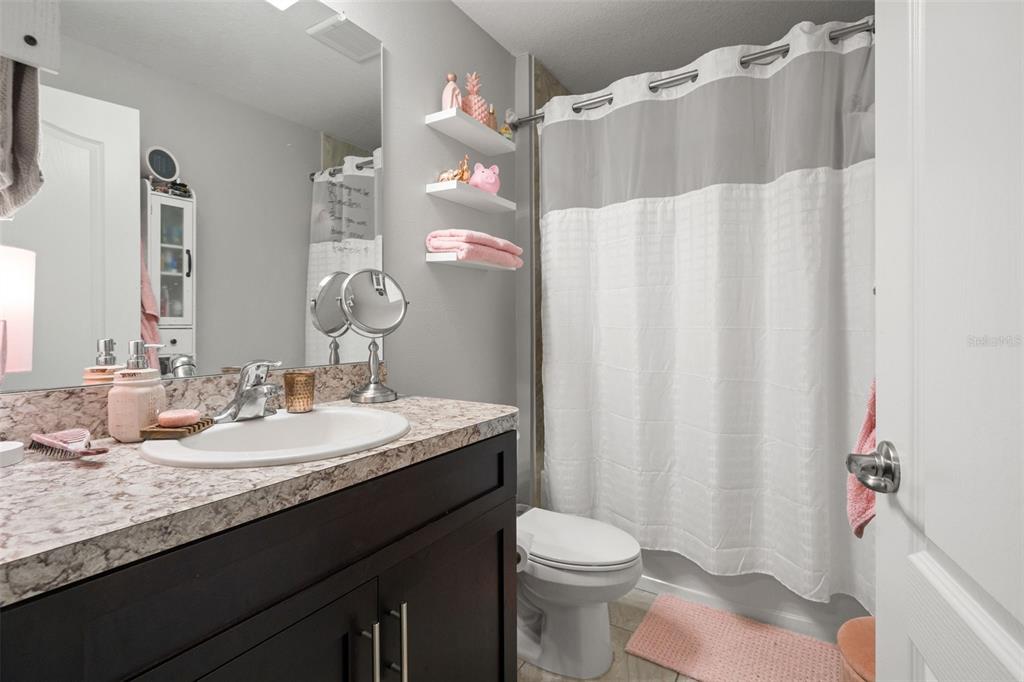 12015 Phoenix Avenue Weeki Wachee, FL 34614 - Photo 24 of 39 a bathroom with a granite countertop sink and a mirror