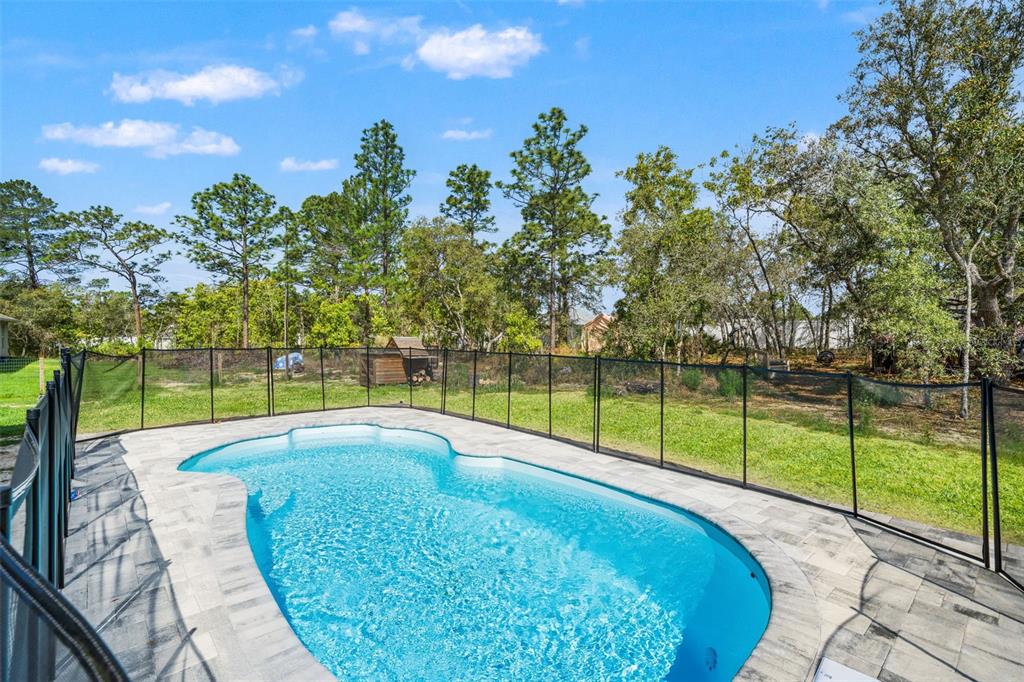 12015 Phoenix Avenue Weeki Wachee, FL 34614 - Photo 30 of 39 a view of swimming pool with a small yard