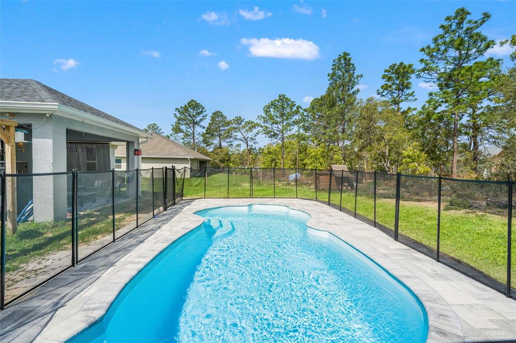 12015 Phoenix Avenue Weeki Wachee, FL 34614 - Photo 31 of 39 a view of yard with swimming pool and green space
