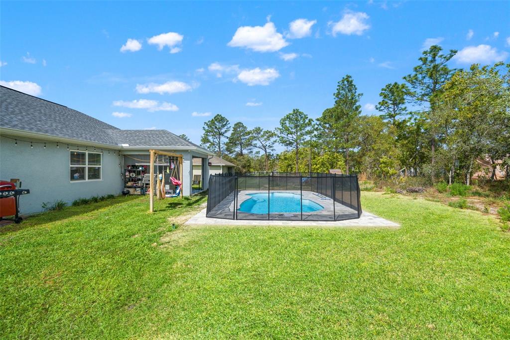 12015 Phoenix Avenue Weeki Wachee, FL 34614 - Photo 32 of 39 a view of a house with a yard porch and sitting area