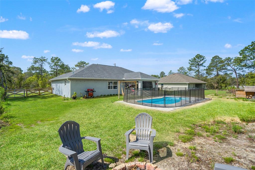 12015 Phoenix Avenue Weeki Wachee, FL 34614 - Photo 33 of 39 a front view of house with yard and outdoor seating