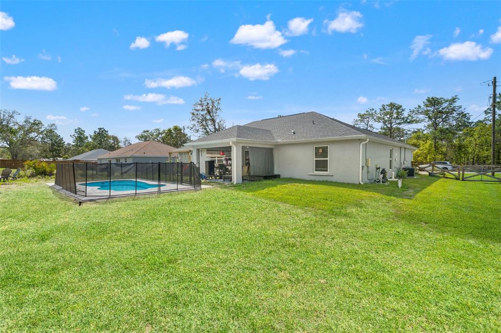 12015 Phoenix Avenue Weeki Wachee, FL 34614 - Photo 34 of 39 a front view of a house with a garden