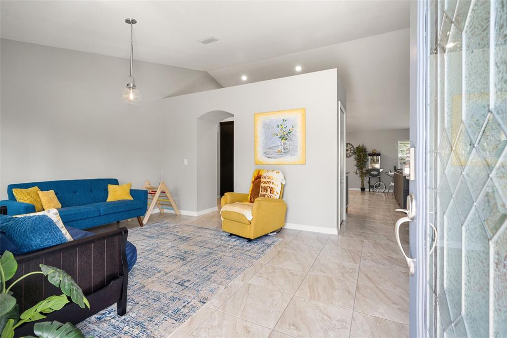 12015 Phoenix Avenue Weeki Wachee, FL 34614 - Photo 5 of 39 a living room with furniture and a chandelier