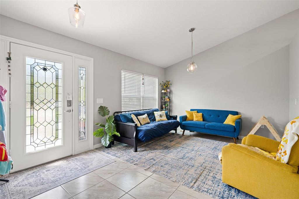12015 Phoenix Avenue Weeki Wachee, FL 34614 - Photo 8 of 39 a living room with furniture and a large window