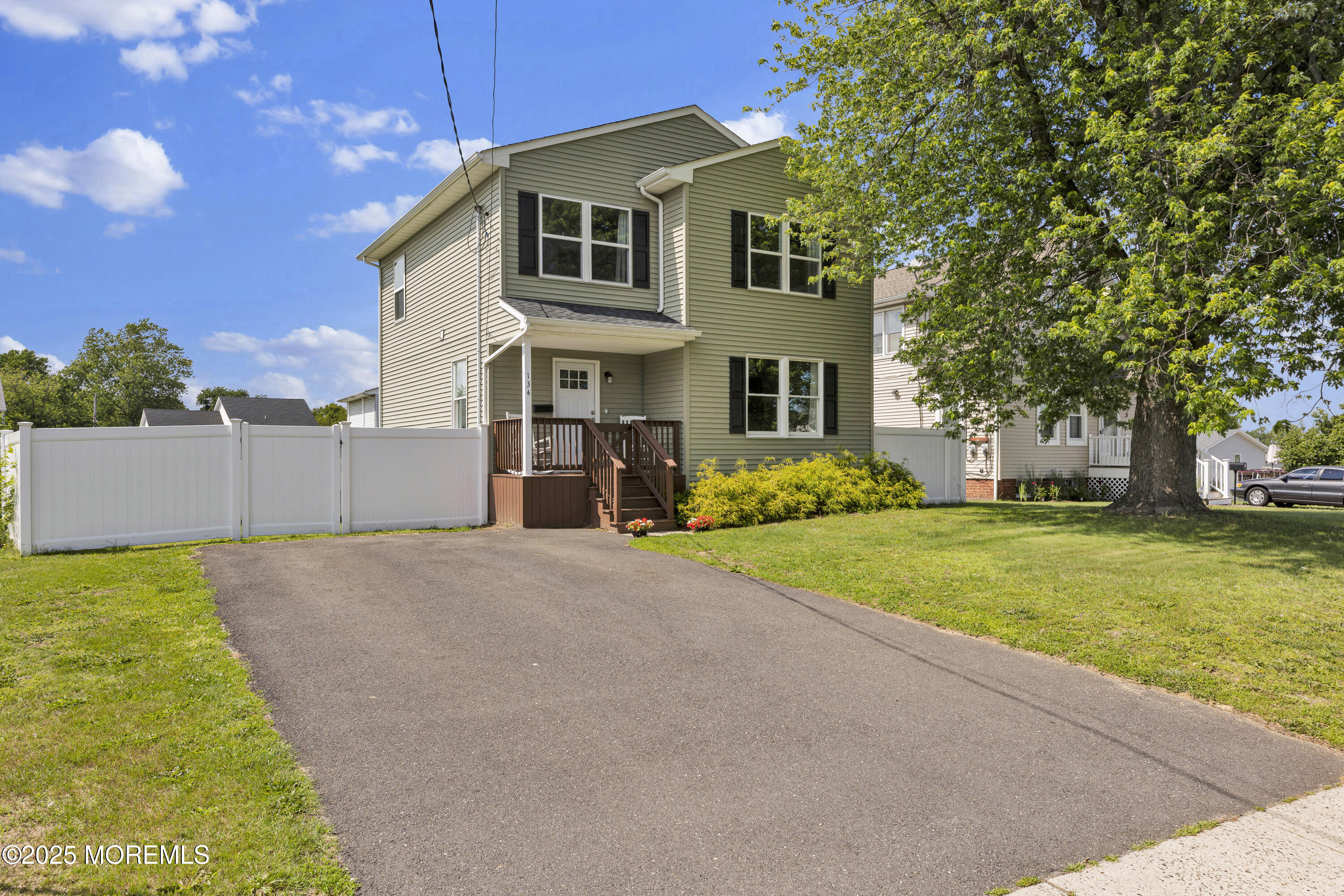 a front view of house with yard and trees