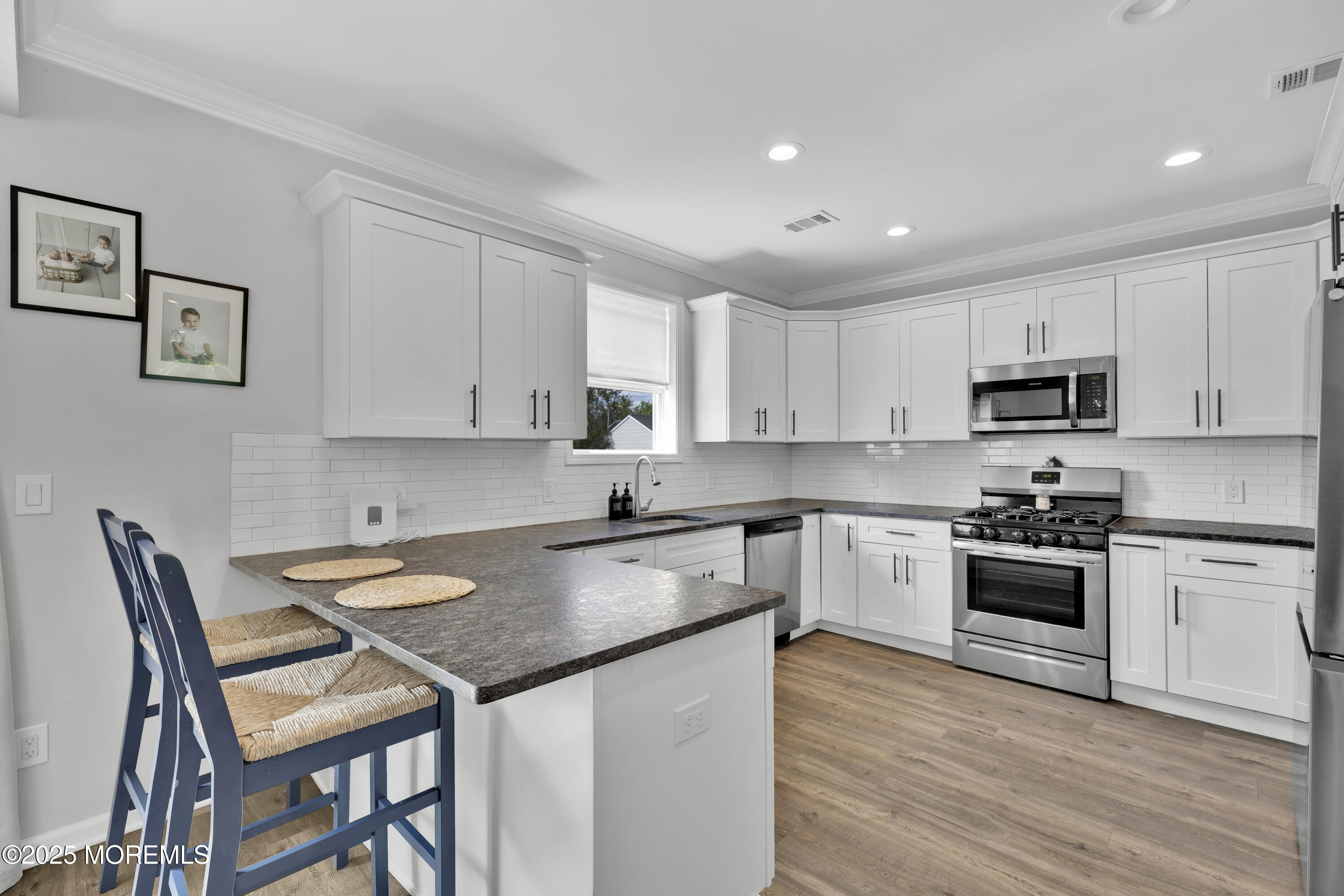 134 County Road Cliffwood, NJ 07721 - Photo 7 of 28 a kitchen with granite countertop white cabinets and stainless steel appliances
