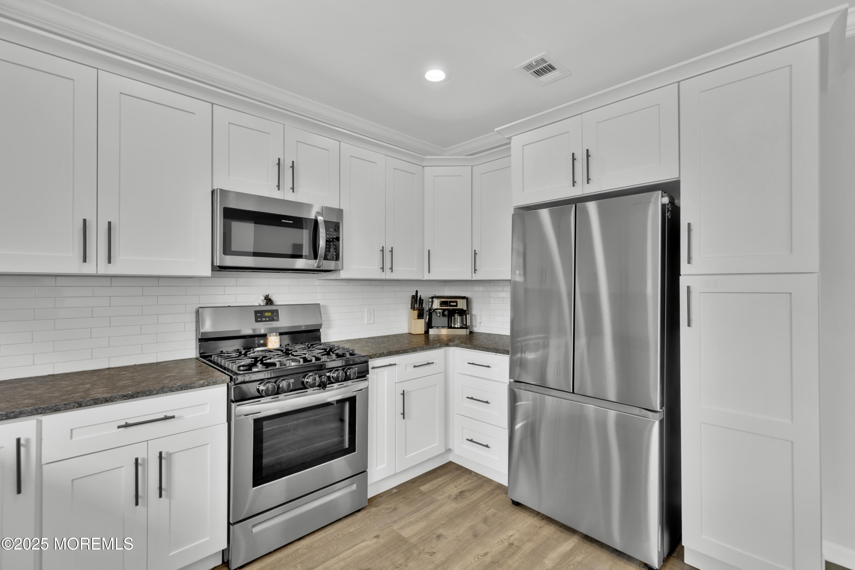 134 County Road Cliffwood, NJ 07721 - Photo 8 of 28 a kitchen with white cabinets and stainless steel appliances