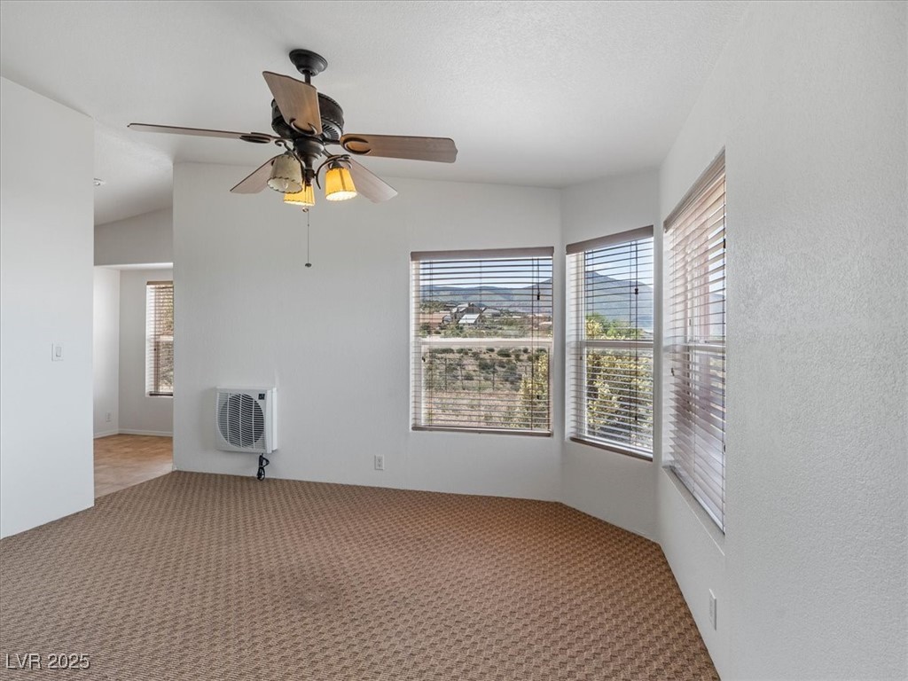 70 West Bonanza Road Las Vegas, NV 89124 - Photo 24 of 71 Carpeted spare room featuring heating unit, healthy amount of natural light, and a ceiling fan