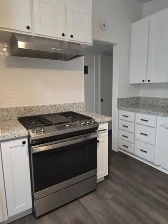 a stove top oven sitting inside of a kitchen