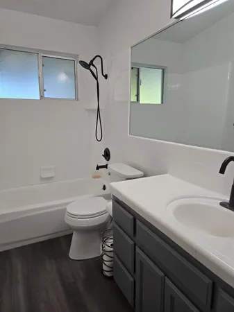 a bathroom with a sink a toilet and shower