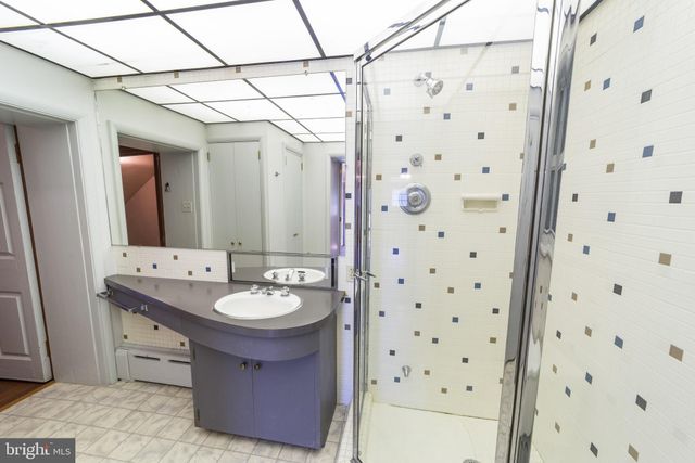 a view of a house with a yard and pathway