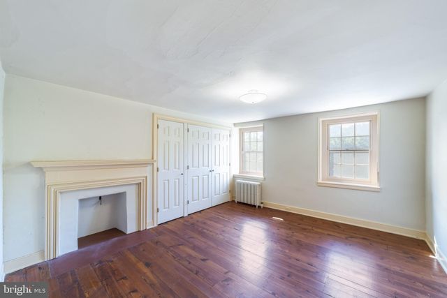 a front view of a house with a garden and yard