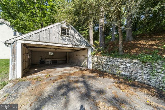 an empty room with wooden floor fireplace and windows