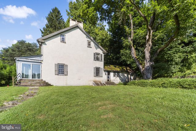a view of a room with wooden floor and windows