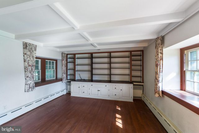 a living room with a fireplace chandelier and a rug
