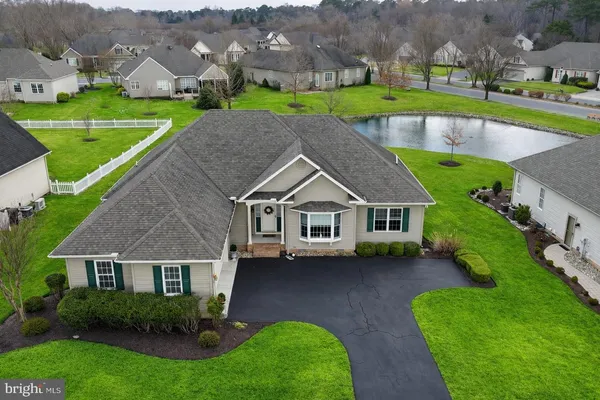 an aerial view of a house with a yard and a large pool