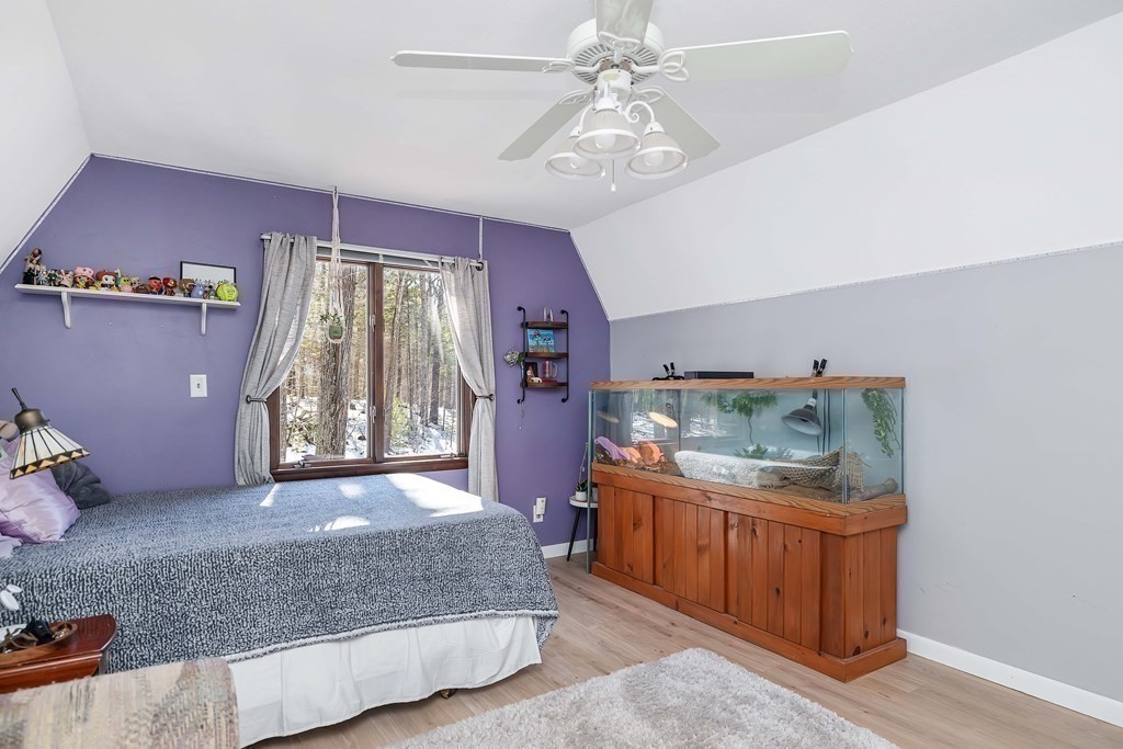 49 Red Bridge Road Wilbraham, MA 01095 - Photo 27 of 40 a bedroom with a bed and a chandelier