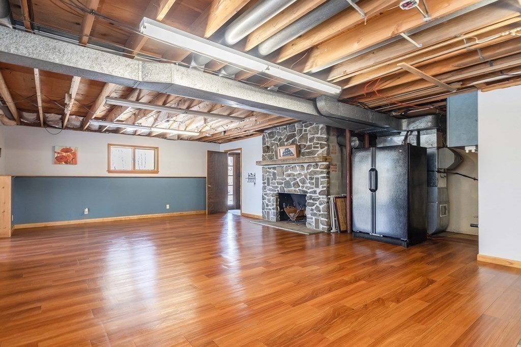 49 Red Bridge Road Wilbraham, MA 01095 - Photo 28 of 40 a view of empty room with wooden floor and fireplace