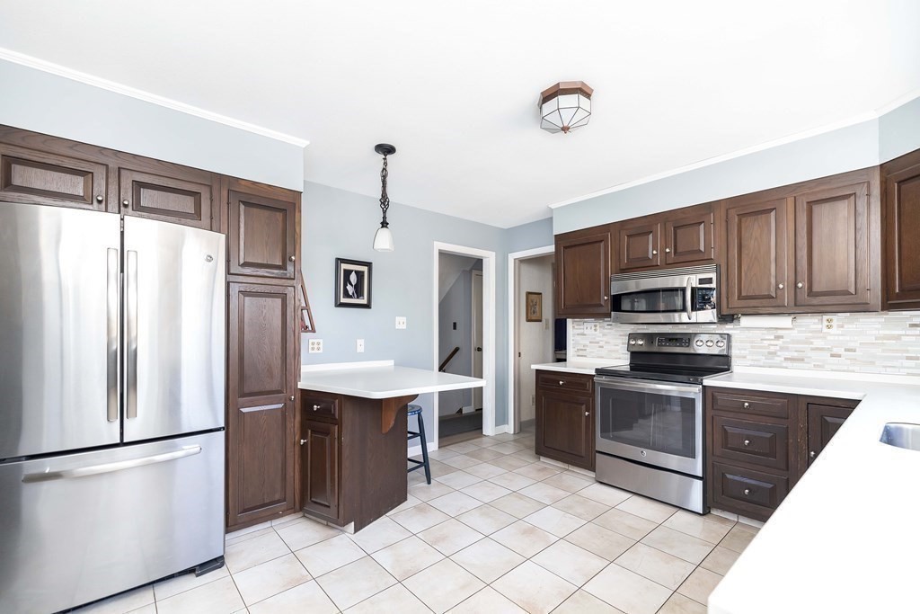 49 Red Bridge Road Wilbraham, MA 01095 - Photo 7 of 40 a kitchen with stainless steel appliances granite countertop a refrigerator sink and stove