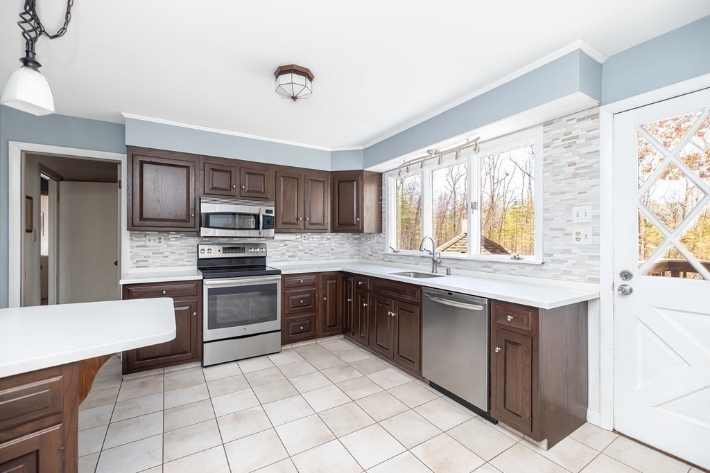49 Red Bridge Road Wilbraham, MA 01095 - Photo 8 of 40 a kitchen with stainless steel appliances granite countertop a stove top oven a sink dishwasher and a refrigerator
