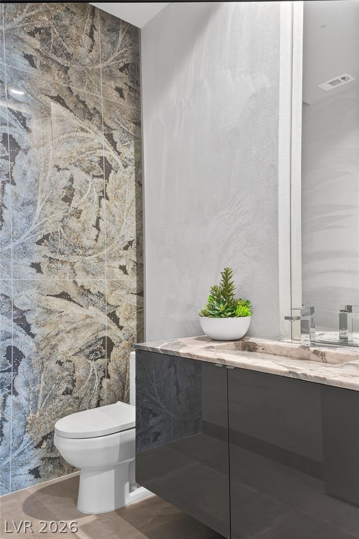 1456 Solitude Ridge Drive Henderson, NV 89012 - Photo 6 of 94 Powder Room with Suede Walls & Sophisticated Tile