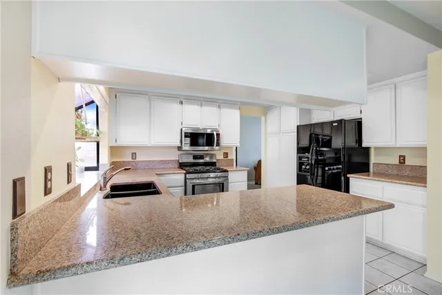 a kitchen with kitchen island granite countertop a sink and counter top space
