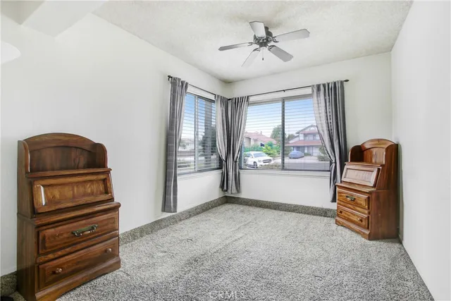 a bathroom with a granite countertop toilet sink and mirror