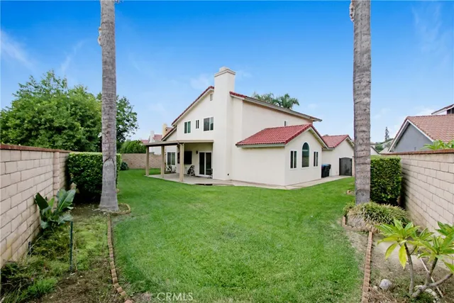 a view of a house with a yard and a garden