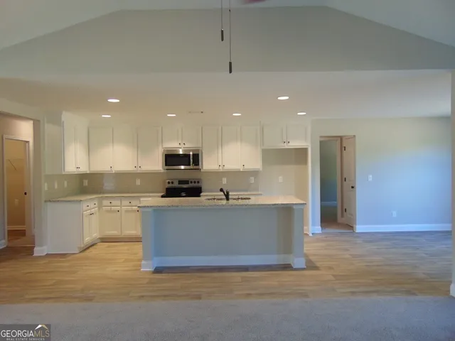 a large kitchen with cabinets and stainless steel appliances
