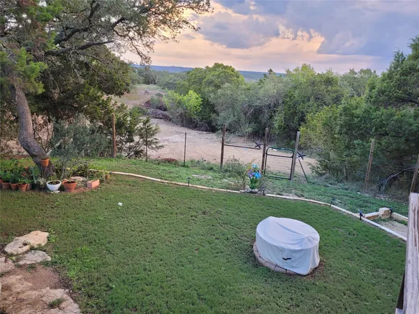 a view of a wooden deck and a yard