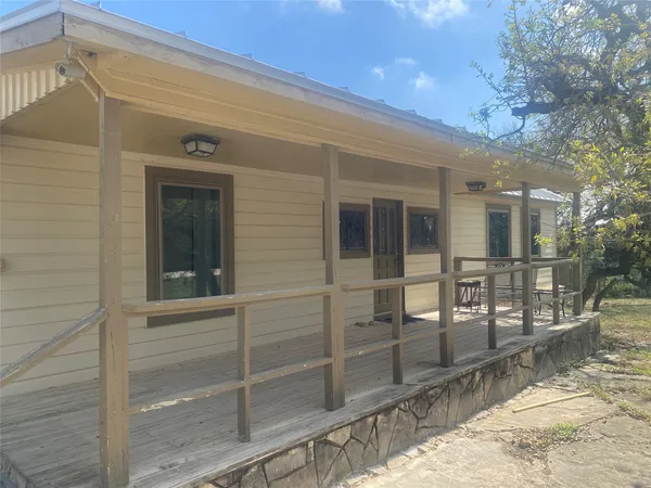 a view of a porch with a door and chair